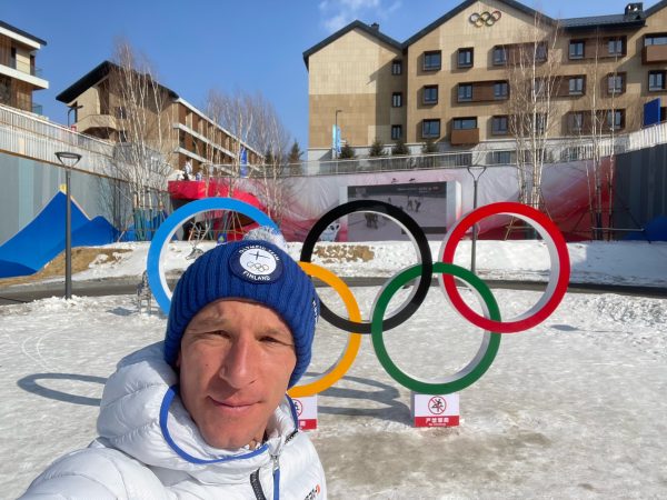 falko krismayr network marketing professional standing in the snow in front of a building.