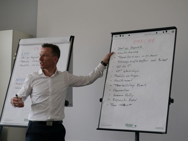 falko krismayr network marketing expert standing in front of a whiteboard giving a presentation.