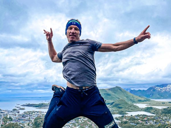 falko krismayr network marketing professional jumping in the air on top of a hill.